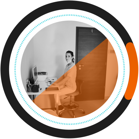 A woman in medical scrubs working at her desk using enterprise grade encrypted software.