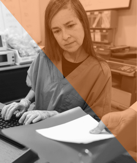 A healthcare professional typing 